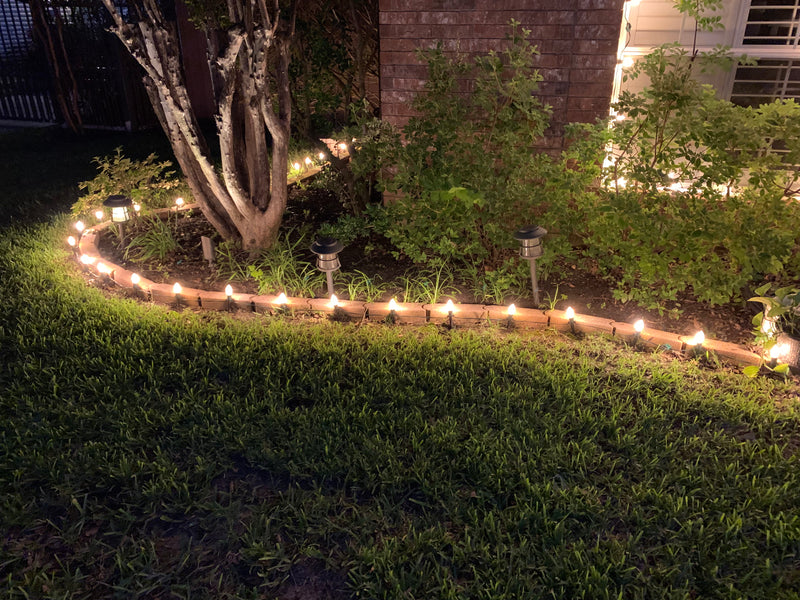 picture of a flower bed outlined with C9 Christmas bulbs